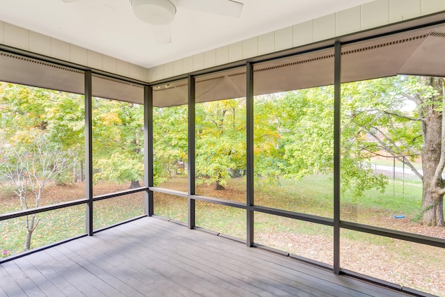 unfurnished sunroom with ceiling fan