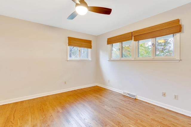 unfurnished room with hardwood / wood-style flooring and ceiling fan