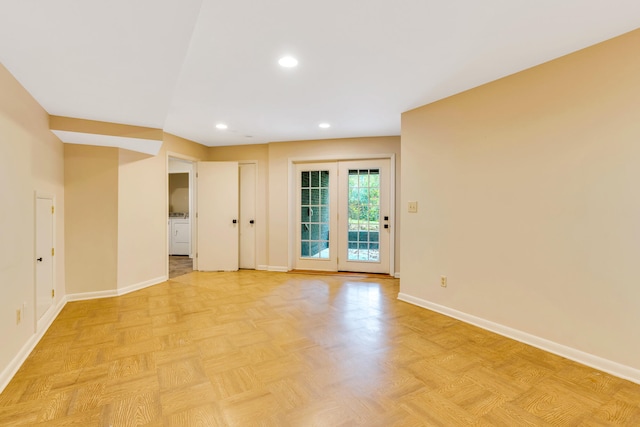 empty room with light parquet flooring and washer / clothes dryer