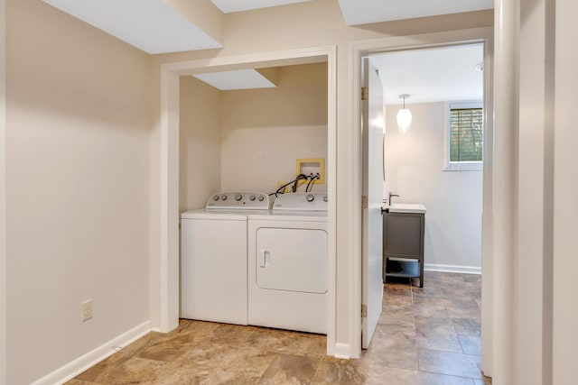 washroom with sink and washer and dryer