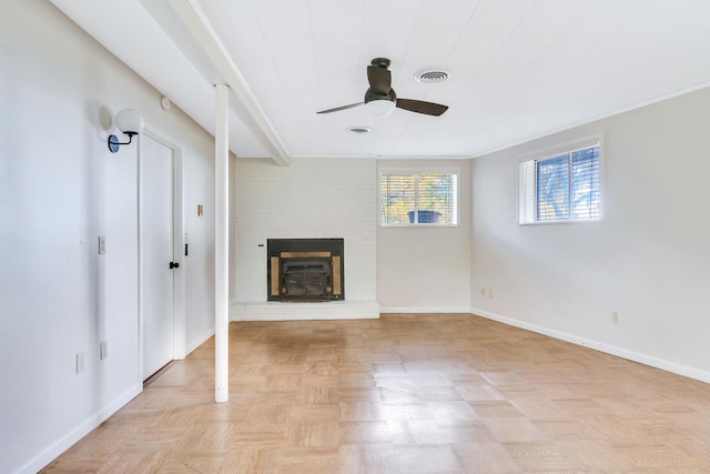 unfurnished living room featuring light parquet flooring, a fireplace, ornamental molding, and ceiling fan