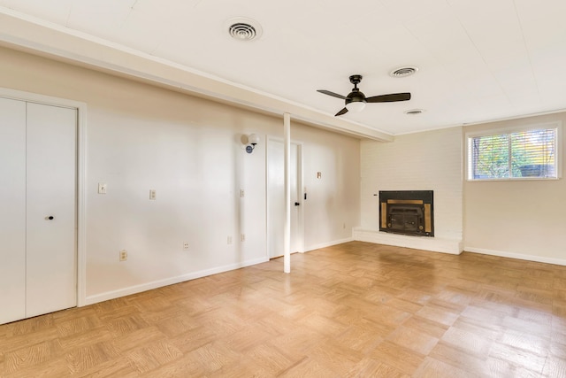 unfurnished living room with a fireplace, ceiling fan, and light parquet floors