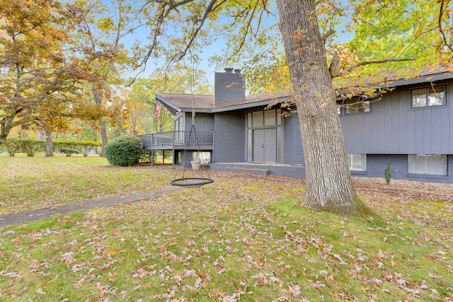 exterior space featuring a deck and a lawn