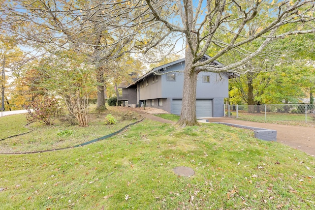 view of home's exterior with a garage and a yard