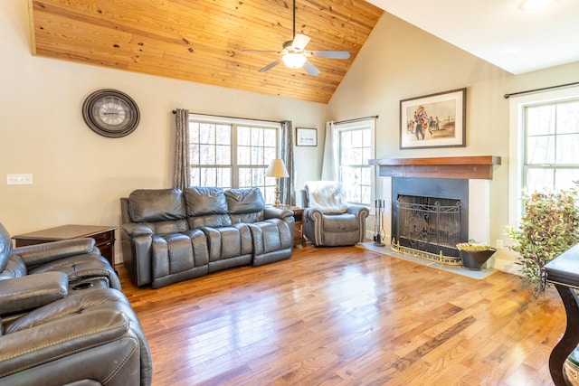 living room featuring light hardwood / wood-style floors, ceiling fan, a healthy amount of sunlight, and high vaulted ceiling