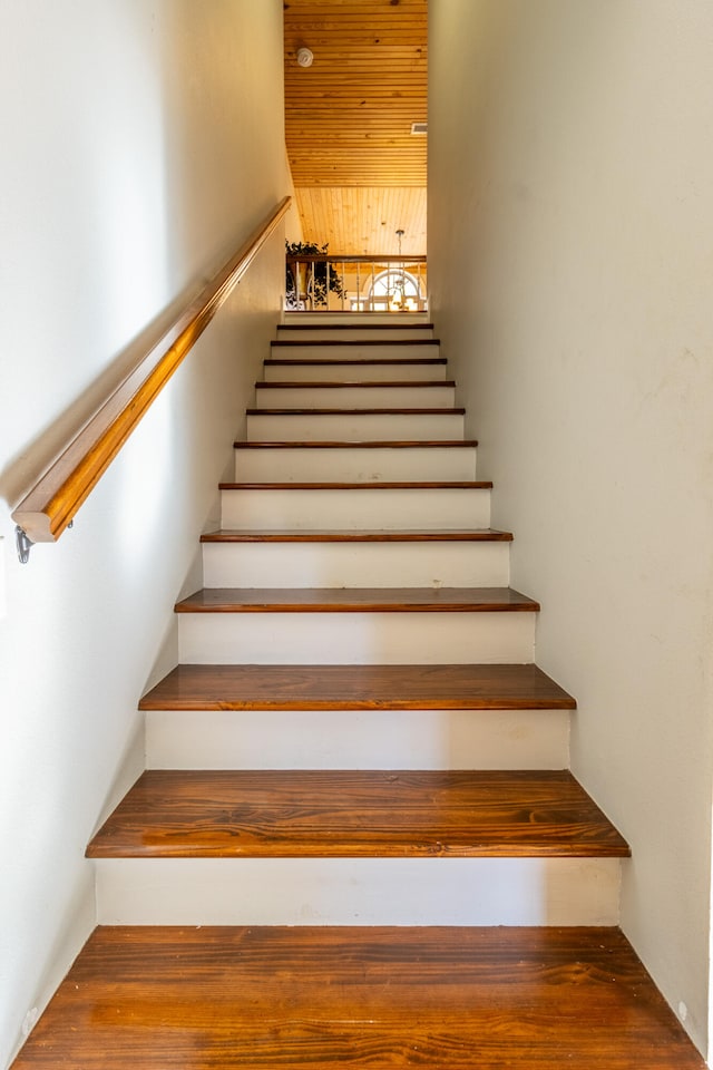 stairway featuring wooden ceiling