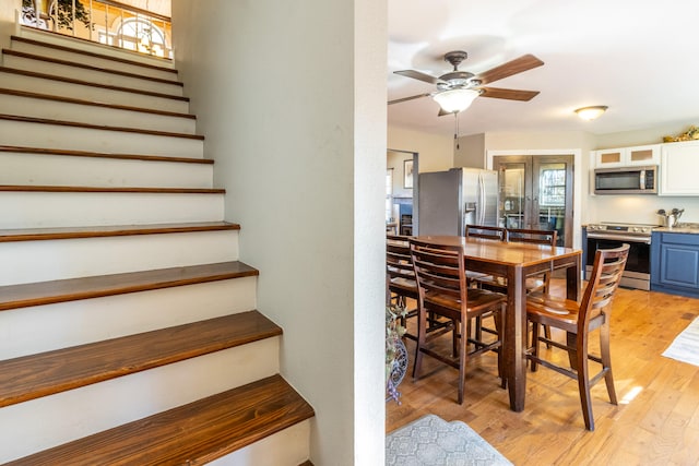 dining room with ceiling fan and light hardwood / wood-style floors