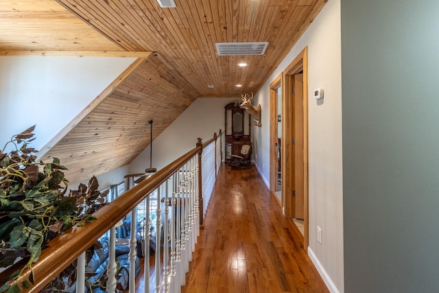 corridor featuring lofted ceiling, hardwood / wood-style flooring, and wooden ceiling