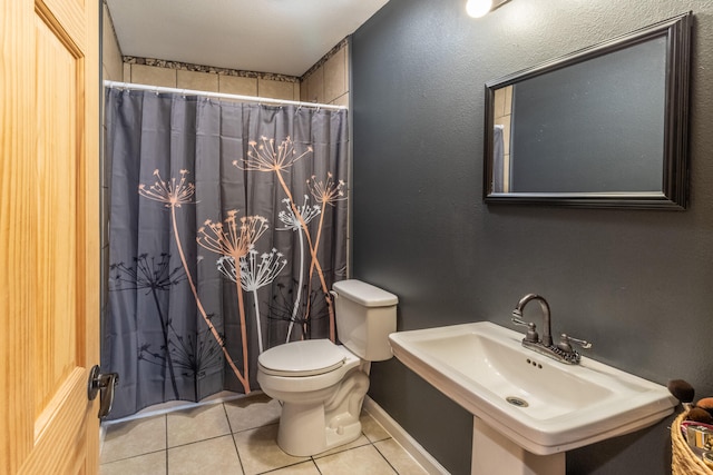 bathroom with toilet, a shower with curtain, sink, and tile patterned floors