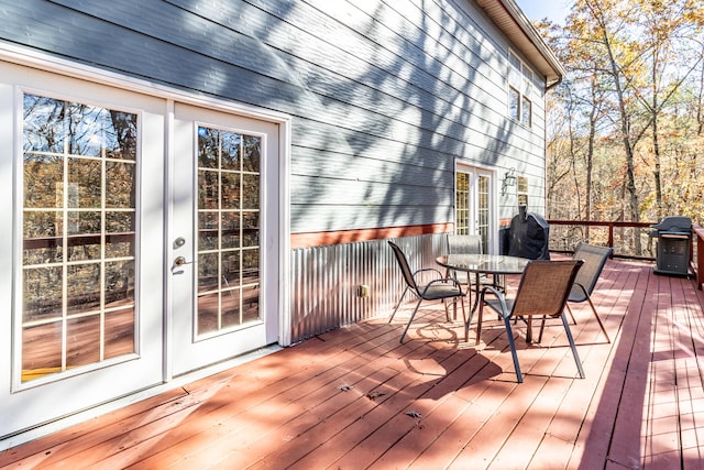 wooden deck featuring area for grilling and french doors