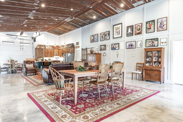 dining area with wooden ceiling and high vaulted ceiling