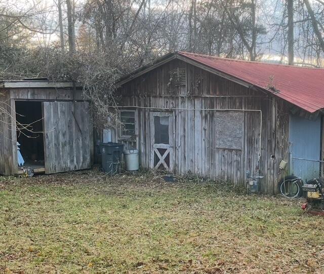 view of outbuilding featuring a lawn