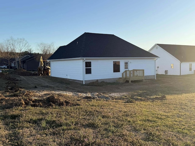 rear view of house featuring a lawn