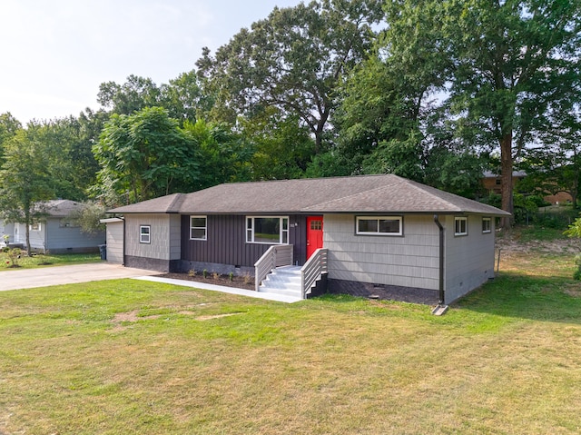 ranch-style home with a garage and a front yard