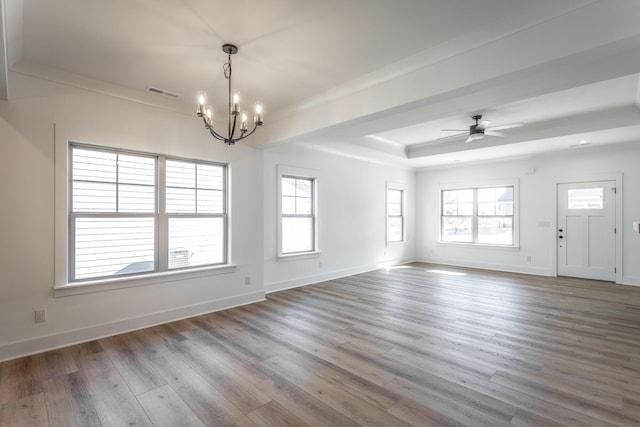 unfurnished room with ornamental molding, ceiling fan with notable chandelier, light wood-type flooring, and a tray ceiling