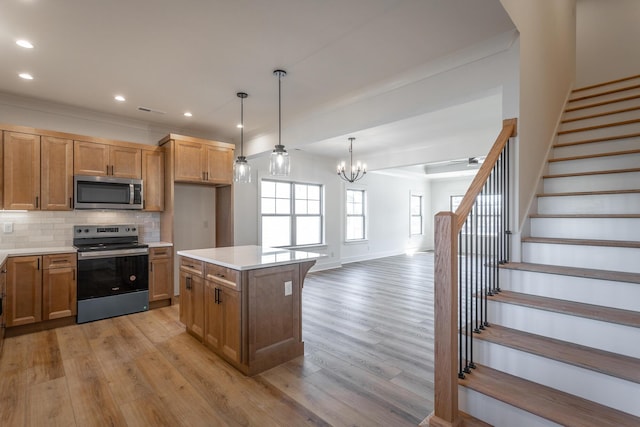 kitchen with a kitchen island, tasteful backsplash, hanging light fixtures, stainless steel appliances, and light wood-type flooring