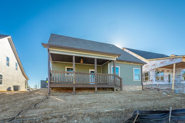 rear view of property featuring central AC