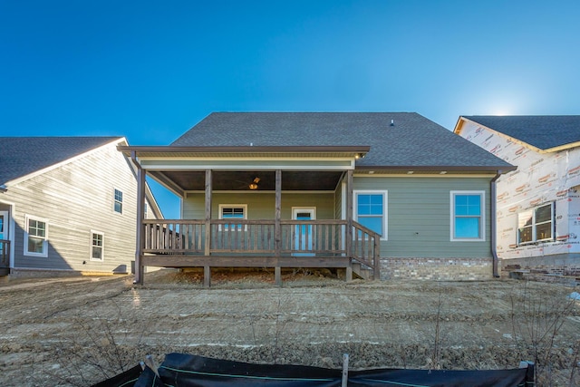 back of property featuring a wooden deck