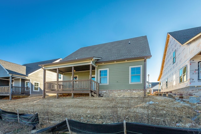 rear view of property with covered porch