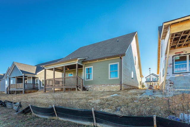 rear view of property with a porch