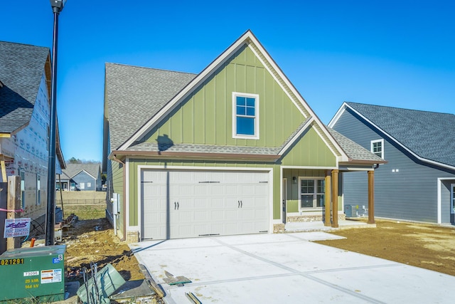 craftsman house featuring a garage and central air condition unit