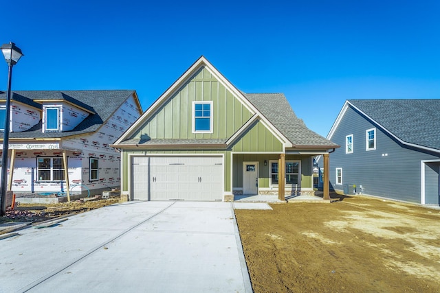 view of front of house with a garage, central AC, and a porch