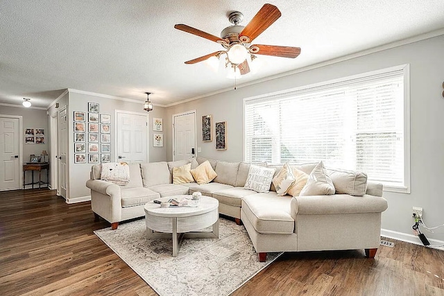 living room with a textured ceiling, dark wood-type flooring, ceiling fan, and a healthy amount of sunlight