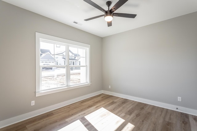 spare room featuring ceiling fan and light wood-type flooring