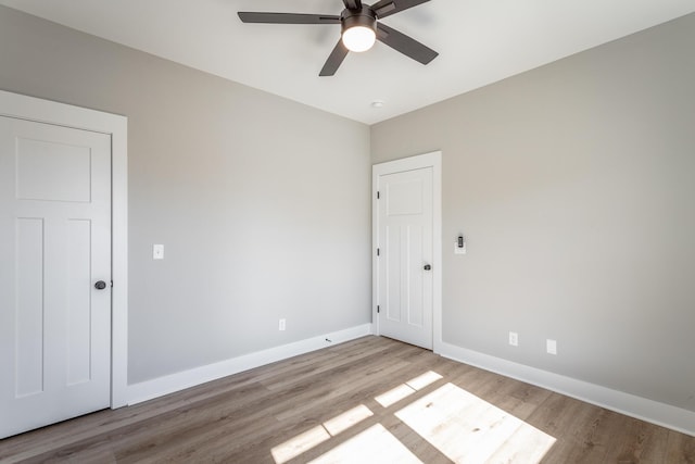 spare room featuring ceiling fan and light wood-type flooring