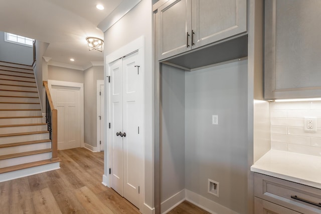 interior space with crown molding and light wood-type flooring