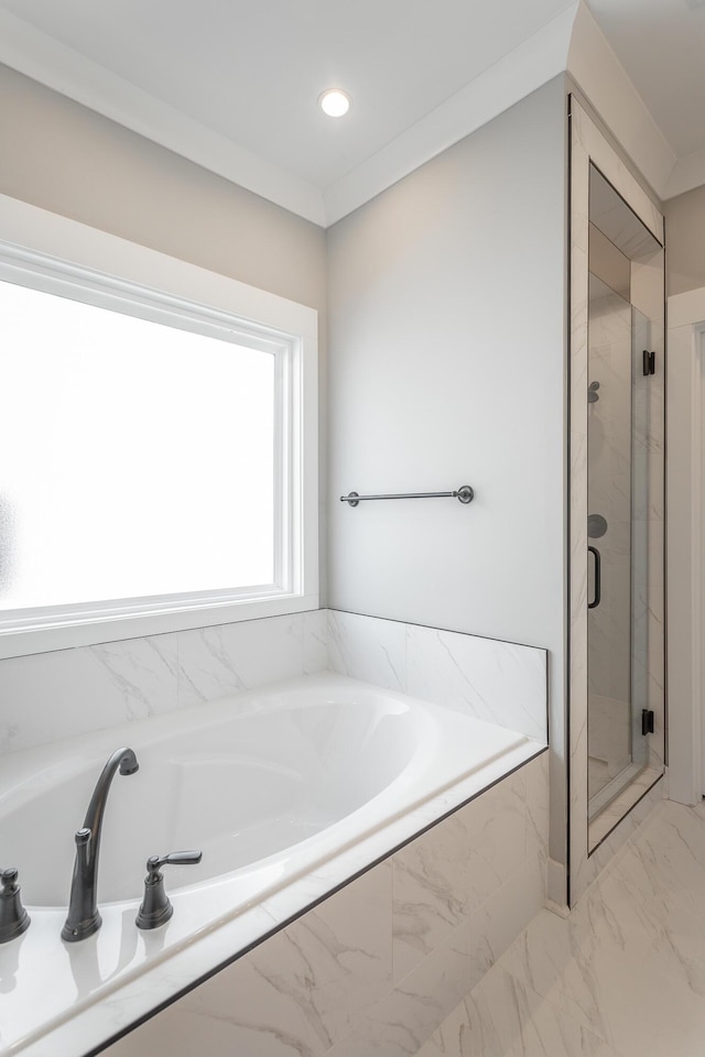 bathroom with crown molding and shower with separate bathtub