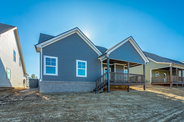 view of front of house featuring a porch and cooling unit