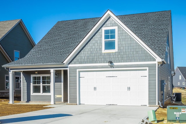 craftsman house with cooling unit and a garage