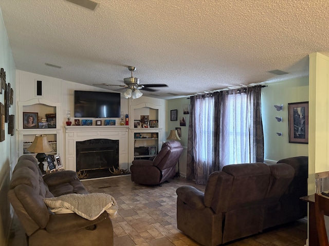 living room featuring a textured ceiling and ceiling fan