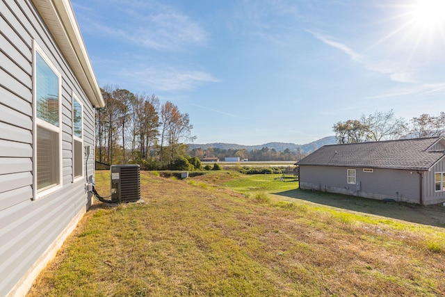 view of yard with central air condition unit and a mountain view