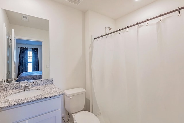 bathroom featuring toilet and vanity