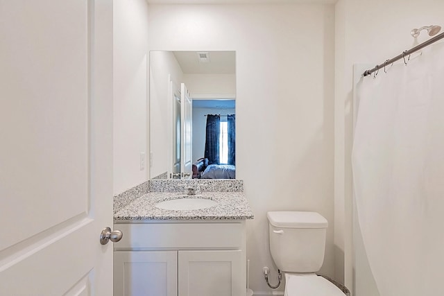 bathroom featuring toilet and vanity