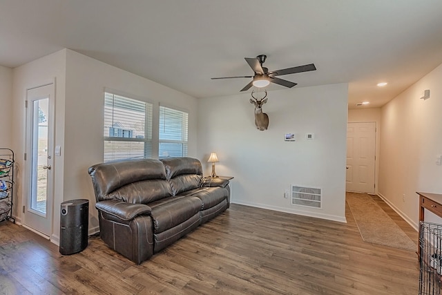 living room with wood-type flooring and ceiling fan