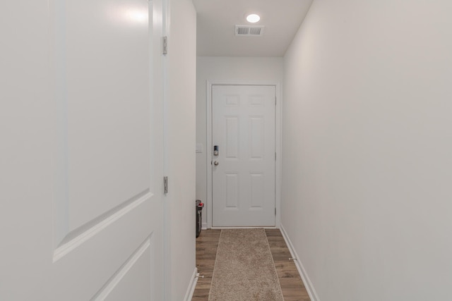 corridor featuring dark hardwood / wood-style flooring