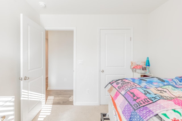 bedroom featuring light carpet