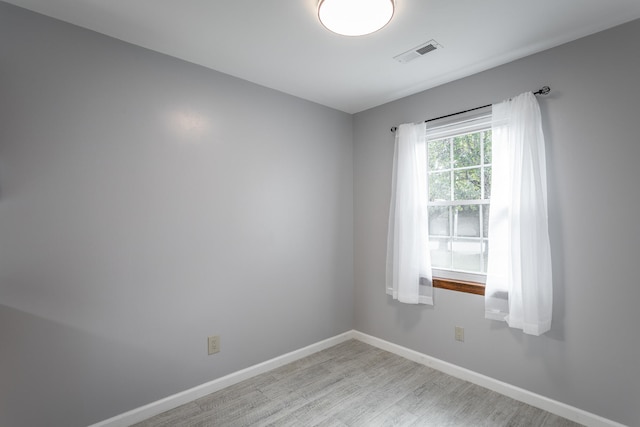 spare room with light hardwood / wood-style flooring