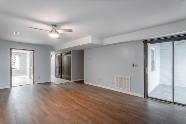 empty room with dark wood-type flooring and ceiling fan