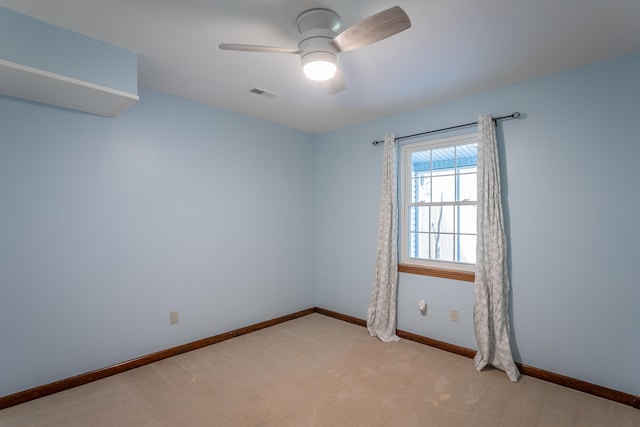 spare room with ceiling fan and light colored carpet