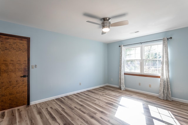 empty room featuring light wood-type flooring and ceiling fan