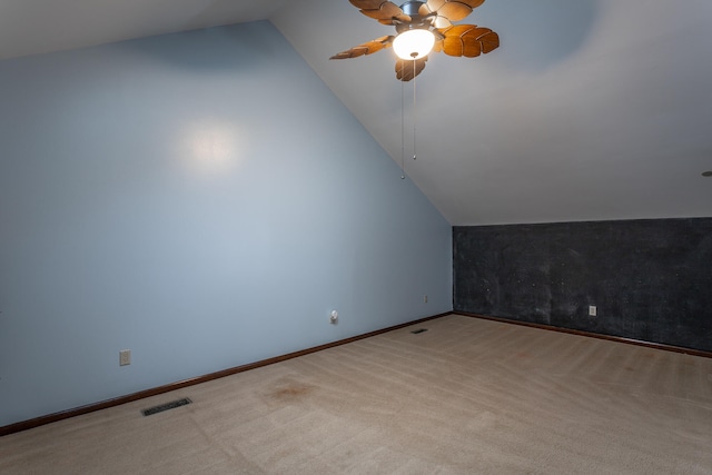 additional living space featuring vaulted ceiling, light colored carpet, and ceiling fan