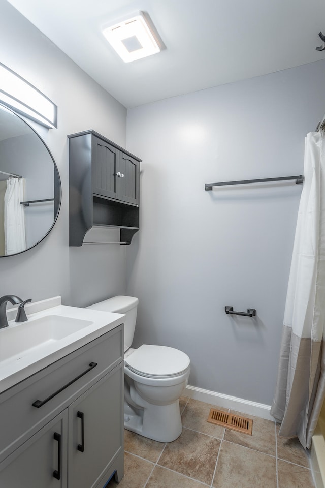 bathroom featuring toilet and vanity