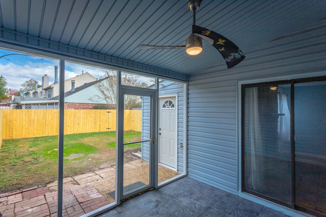 unfurnished sunroom with lofted ceiling, ceiling fan, and wood ceiling