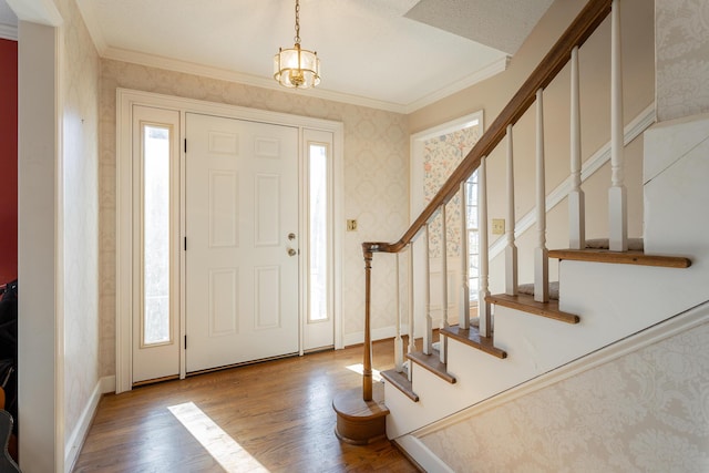 entryway featuring hardwood / wood-style flooring and ornamental molding