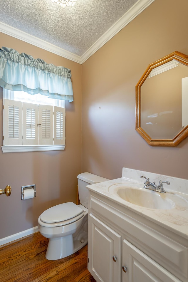 bathroom featuring hardwood / wood-style floors, vanity, ornamental molding, a textured ceiling, and toilet