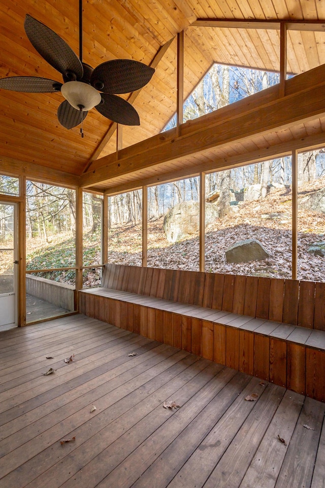 unfurnished sunroom featuring ceiling fan, lofted ceiling, and wooden ceiling